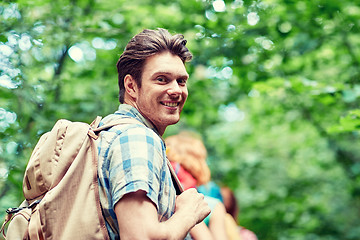 Image showing group of smiling friends with backpacks hiking