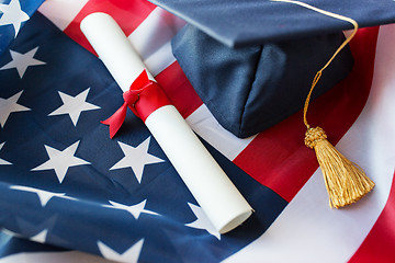 Image showing mortarboard and diploma on american flag