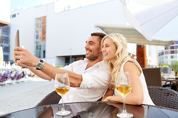 Image showing happy couple taking selfie with tablet pc at cafe