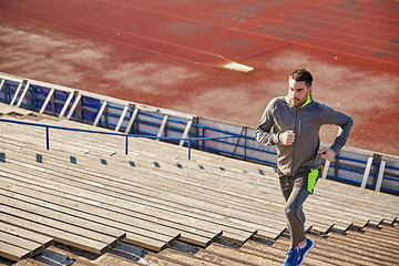 Image showing young man running upstairs on stadium