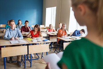 Image showing group of students and girl with notebook at school