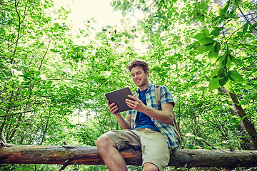 Image showing happy man with backpack and tablet pc in woods