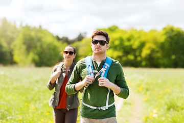 Image showing couple with backpacks hiking outdoors