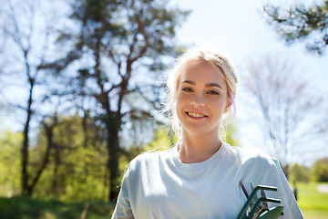 Image showing happy young volunteer woman outdoors