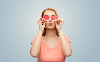 Image showing happy young woman with red heart shapes on eyes