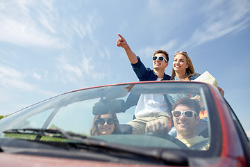 Image showing happy friends driving in cabriolet car