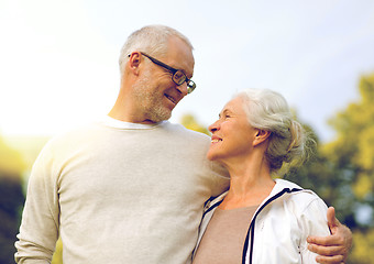 Image showing senior couple hugging in city park