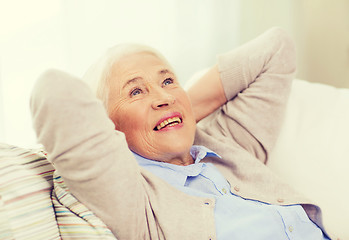 Image showing happy senior woman resting on sofa at home