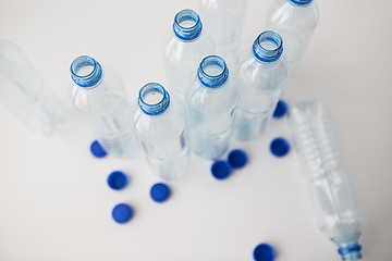 Image showing close up of empty water bottles and caps on table