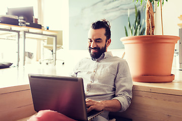 Image showing happy creative male office worker with laptop