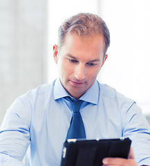 Image showing businessman with tablet pc in office