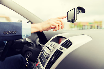 Image showing close up of man with gps navigator driving car