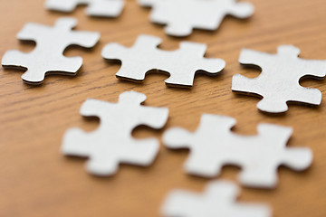 Image showing close up of puzzle pieces on wooden surface