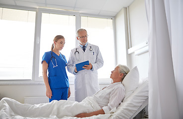 Image showing doctor and nurse visiting senior woman at hospital