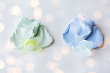 Image showing close up of baby mittens and soothers for twins