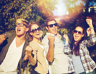 Image showing group of happy friends showing triumph gesture