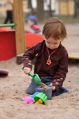 Image showing little girl playing at sand-box