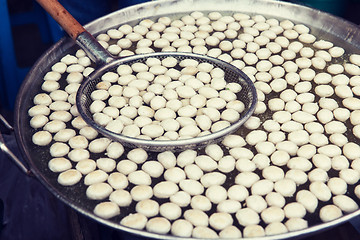 Image showing meat or rice balls frying in oil at street market