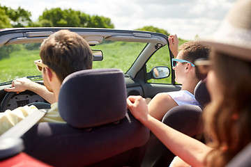 Image showing happy friends driving in cabriolet car