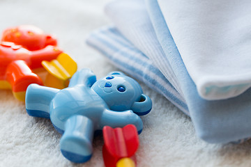 Image showing close up of baby rattle and clothes for newborn