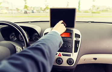 Image showing close up of young man with tablet pc driving car