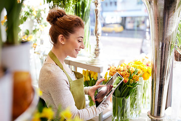 Image showing woman with tablet pc computer at flower shop