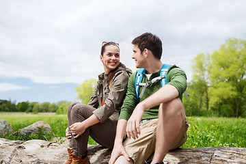 Image showing smiling couple with backpacks in nature