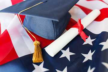 Image showing bachelor hat and diploma on american flag