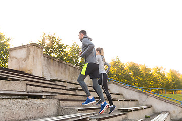 Image showing couple running upstairs on stadium