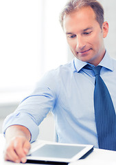 Image showing businessman with tablet pc and coffee in office