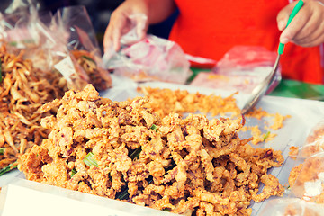 Image showing close up of cook hands and snacks at street market