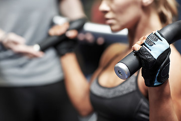 Image showing man and woman flexing muscles on gym machine