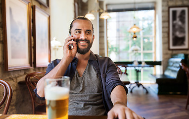 Image showing man with smartphone and beer calling at bar or pub