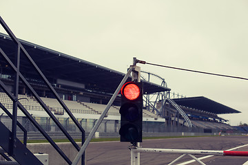 Image showing red traffic lights and road sign on race track