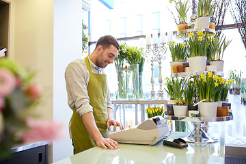 Image showing florist man or seller at flower shop counter