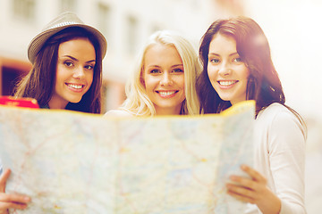 Image showing beautiful girls looking into tourist map in city