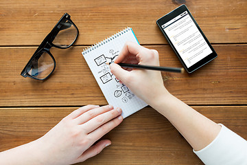 Image showing close up of woman or student writing to notepad