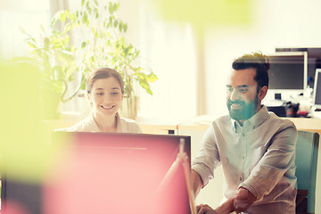 Image showing happy creative team with computer in office