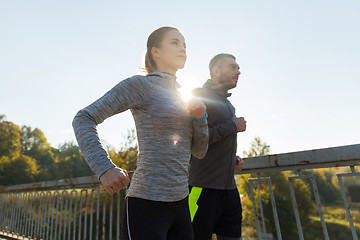 Image showing happy couple running outdoors