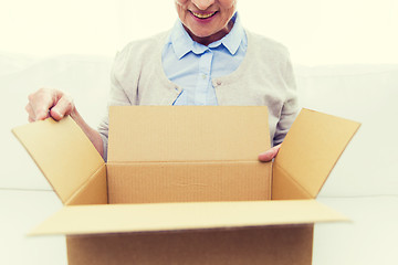 Image showing close up of senior woman with parcel box at home