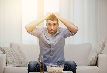 Image showing sad man watching sports at home