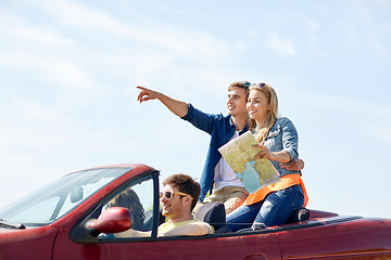 Image showing happy friends driving in cabriolet car