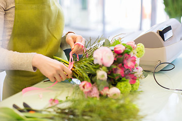 Image showing close up of woman making bunch at flower shop