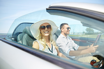 Image showing happy man and woman driving in cabriolet car