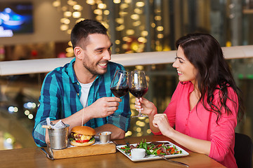 Image showing happy couple dining and drink wine at restaurant