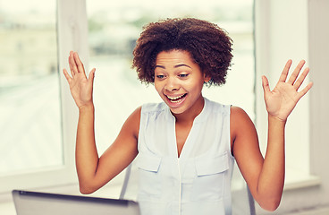 Image showing happy african woman with laptop at office