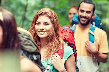 Image showing group of smiling friends with backpacks hiking