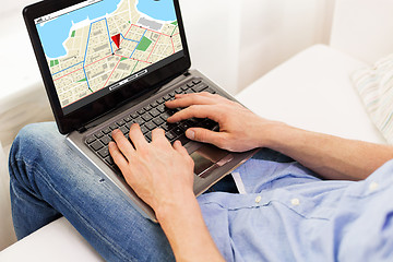 Image showing close up of man typing on laptop computer at home