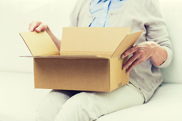 Image showing close up of senior woman with parcel box at home