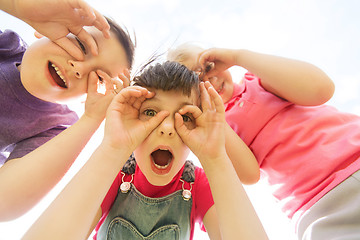 Image showing group of kids having fun and making faces outdoors